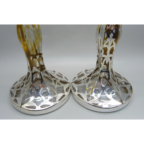 811 - A pair of silver covered glass candlesticks, 19cm,(lacking some silver detail)