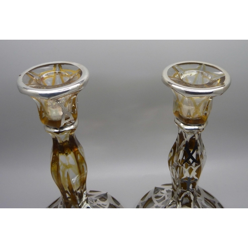 811 - A pair of silver covered glass candlesticks, 19cm,(lacking some silver detail)