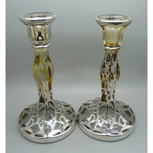 811 - A pair of silver covered glass candlesticks, 19cm,(lacking some silver detail)