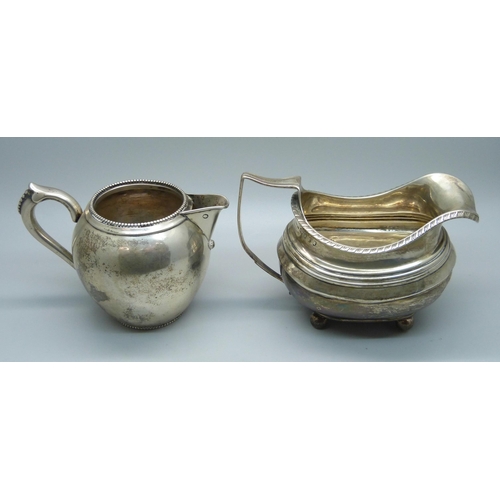 814 - A continental silver jug with foreign control marks and a 19th Century silver cream jug, a/f, repair... 