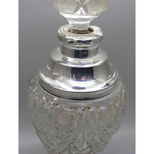 823 - A cut glass scent bottle with silver collar, collar dented, 23.5cm