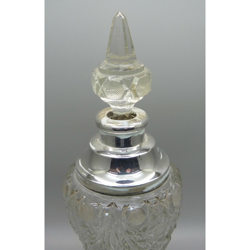 823 - A cut glass scent bottle with silver collar, collar dented, 23.5cm