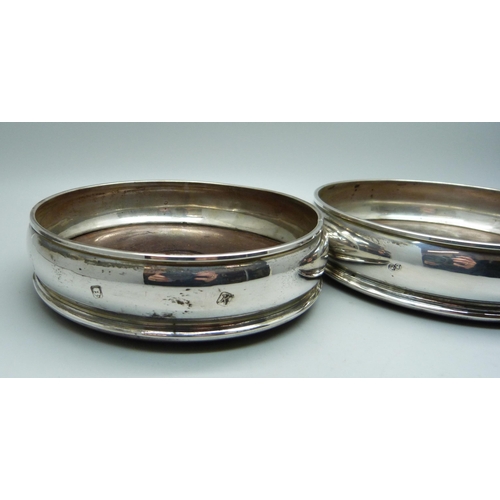 829 - A pair of silver wine bottle coasters