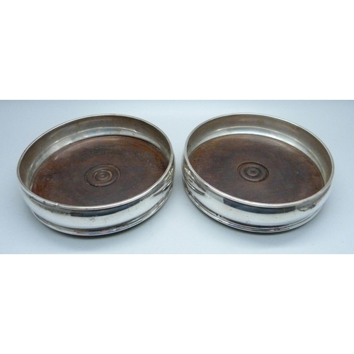 829 - A pair of silver wine bottle coasters