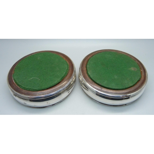 829 - A pair of silver wine bottle coasters