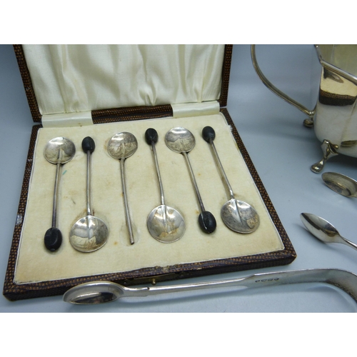 835 - Three pairs of silver sugar bows, a silver sugar bowl and six silver coffee bean spoons, (one a/f), ... 