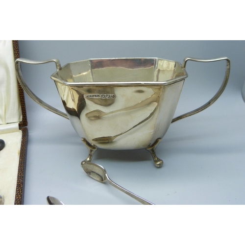 835 - Three pairs of silver sugar bows, a silver sugar bowl and six silver coffee bean spoons, (one a/f), ... 