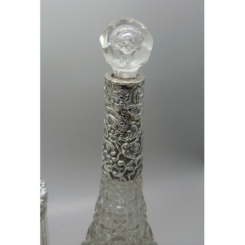 837 - Ten silver topped glass bottles including a globular glass scent bottle, lid a/f