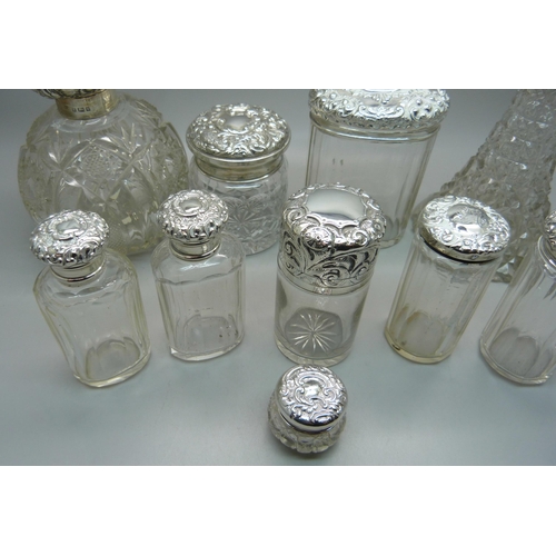 837 - Ten silver topped glass bottles including a globular glass scent bottle, lid a/f