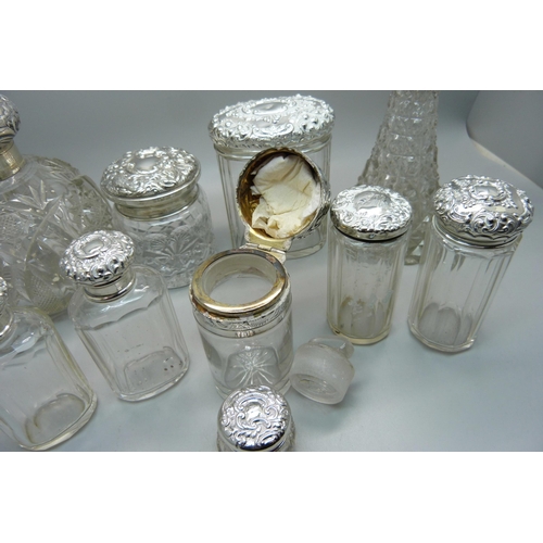 837 - Ten silver topped glass bottles including a globular glass scent bottle, lid a/f