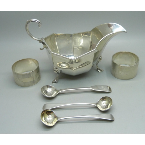 841 - A silver sauce boat, two silver napkin rings, a pair of silver mustard spoons and one other silver m... 