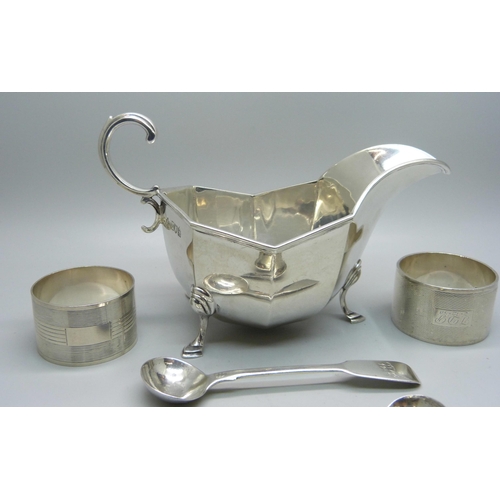 841 - A silver sauce boat, two silver napkin rings, a pair of silver mustard spoons and one other silver m... 