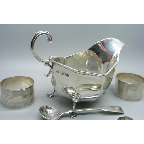 841 - A silver sauce boat, two silver napkin rings, a pair of silver mustard spoons and one other silver m... 