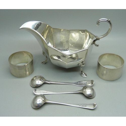 841 - A silver sauce boat, two silver napkin rings, a pair of silver mustard spoons and one other silver m... 