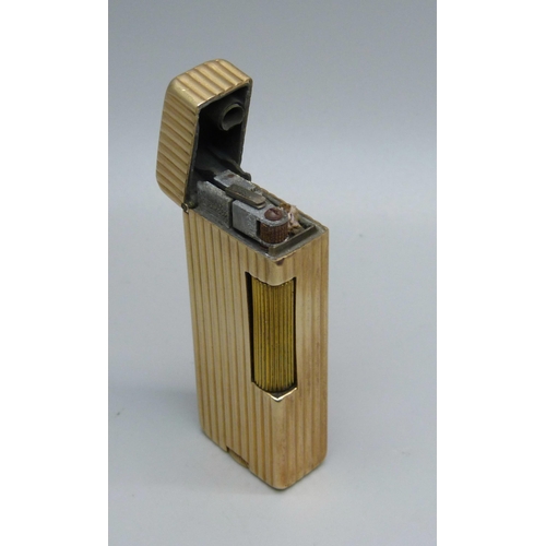 853 - A 14ct gold cased Dunhill lighter, marked 'Outer Jacket 14K Gold'