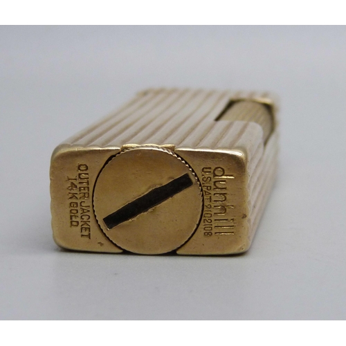 853 - A 14ct gold cased Dunhill lighter, marked 'Outer Jacket 14K Gold'