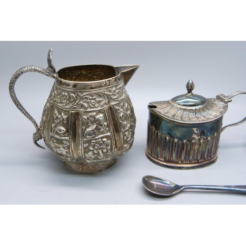 856 - A Victorian silver mustard, 48g, (plated spoon), an Indian white metal jug with snake handle, 102g, ... 