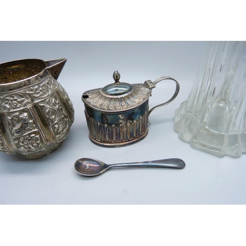 856 - A Victorian silver mustard, 48g, (plated spoon), an Indian white metal jug with snake handle, 102g, ... 