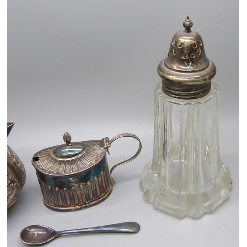 856 - A Victorian silver mustard, 48g, (plated spoon), an Indian white metal jug with snake handle, 102g, ... 