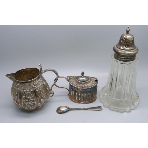 856 - A Victorian silver mustard, 48g, (plated spoon), an Indian white metal jug with snake handle, 102g, ... 