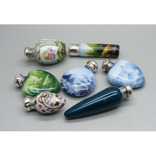 862 - A collection of seven hand painted continental scent bottles with hallmarked silver lids, all lids d... 