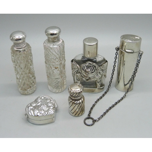 863 - A silver pill box and five silver and silver mounted scent bottles