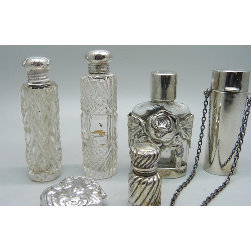 863 - A silver pill box and five silver and silver mounted scent bottles