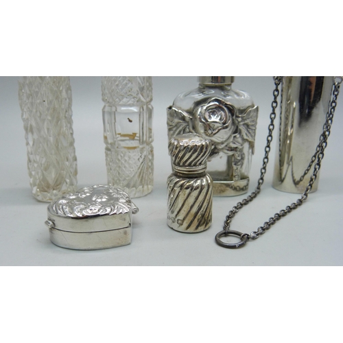 863 - A silver pill box and five silver and silver mounted scent bottles