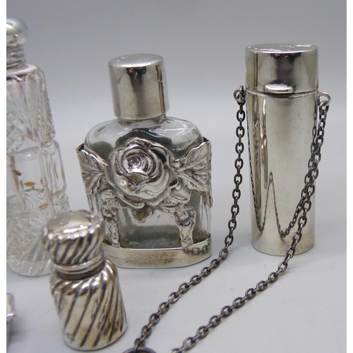 863 - A silver pill box and five silver and silver mounted scent bottles