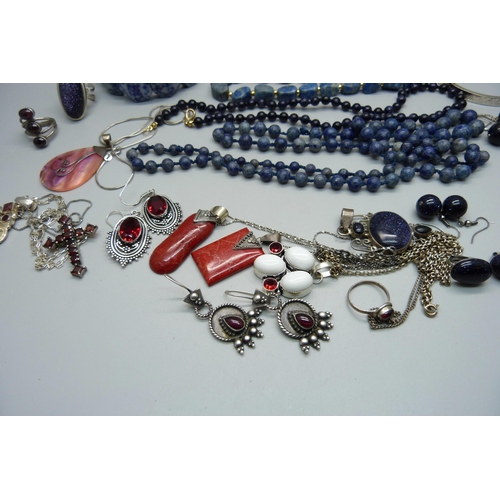 869 - A collection of silver and silver set blue stone jewellery