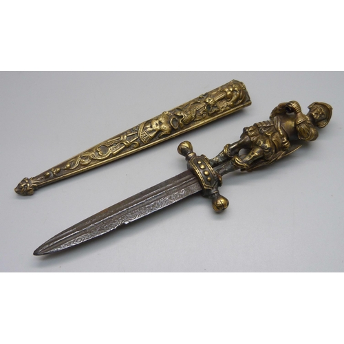 901 - A European brass dagger and scabbard with figural handle, overall length 26cm