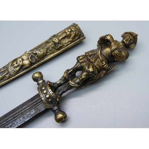 901 - A European brass dagger and scabbard with figural handle, overall length 26cm