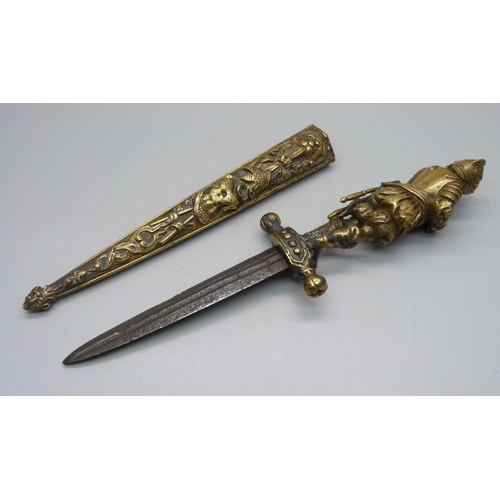 901 - A European brass dagger and scabbard with figural handle, overall length 26cm