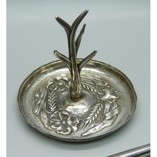 915 - A silver ring stand, 20g and a silver handled button hook