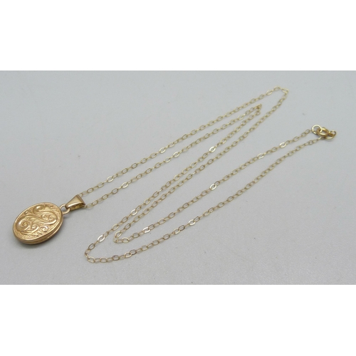 973 - A 9ct gold locket and chain, 1.1g