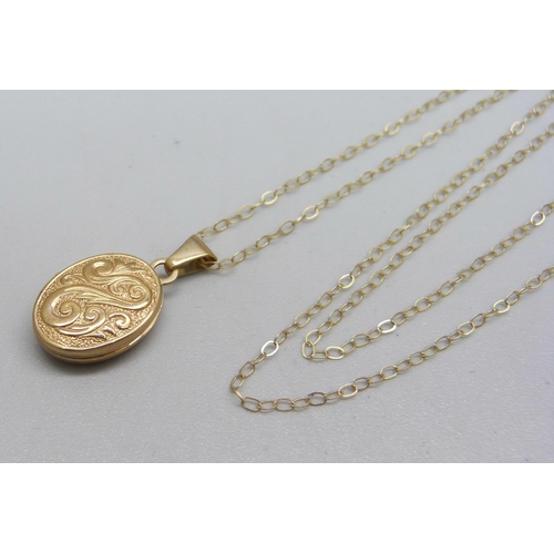 973 - A 9ct gold locket and chain, 1.1g