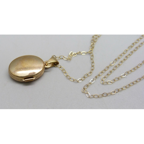 973 - A 9ct gold locket and chain, 1.1g