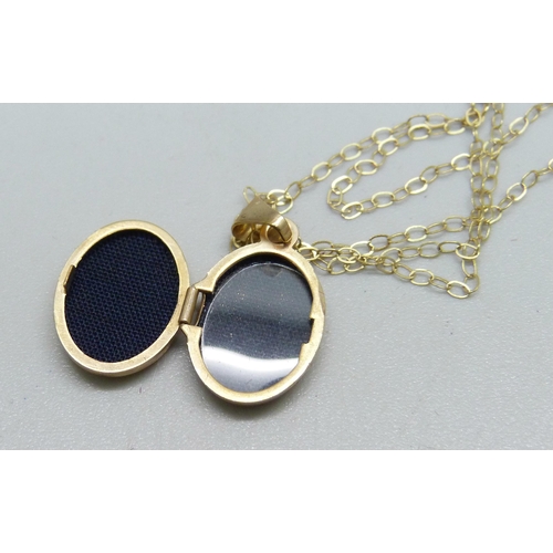 973 - A 9ct gold locket and chain, 1.1g