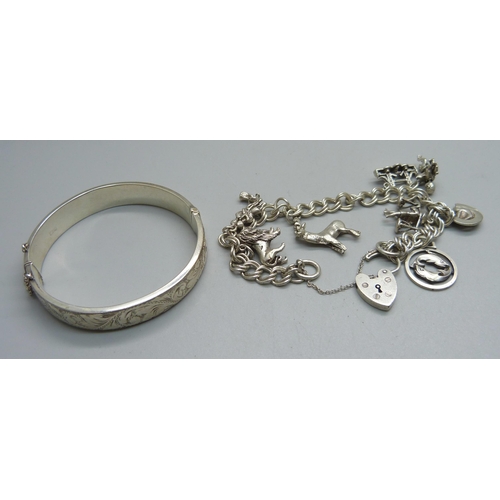 979B - A silver bangle and a silver charm bracelet, 51g