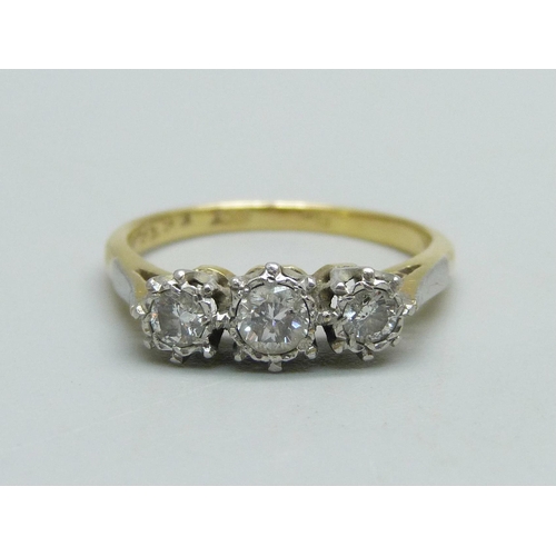 991 - An 18ct gold and three stone diamond ring, 3.1g, N, centre stone approximately 0.25 carat