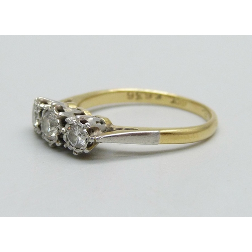 991 - An 18ct gold and three stone diamond ring, 3.1g, N, centre stone approximately 0.25 carat