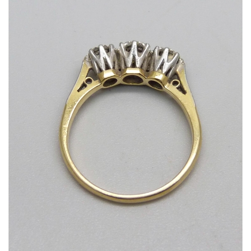 991 - An 18ct gold and three stone diamond ring, 3.1g, N, centre stone approximately 0.25 carat