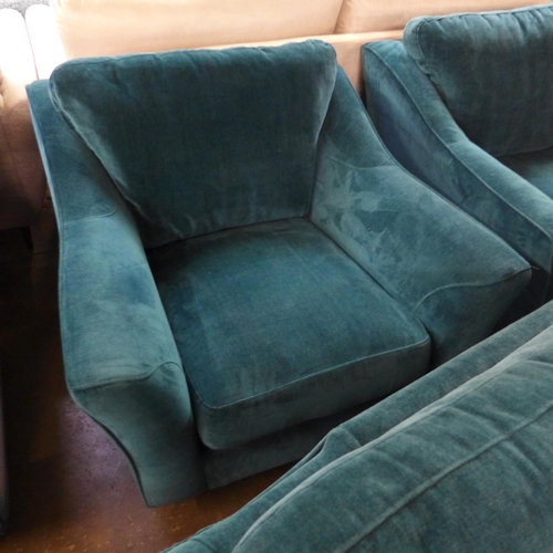 1403 - A turquoise velvet three seater sofa and two armchairs - damaged frame on sofa