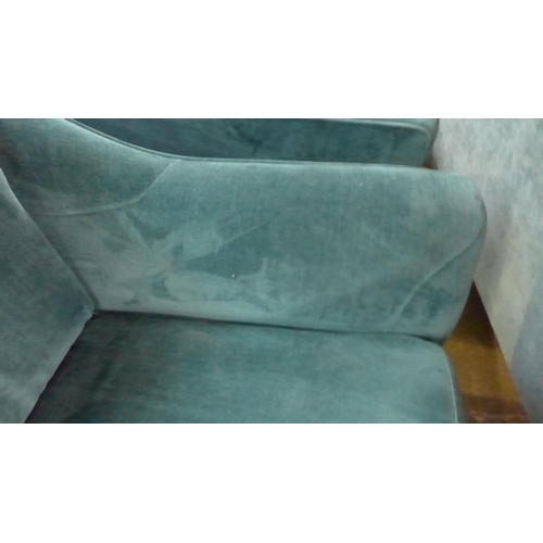 1403 - A turquoise velvet three seater sofa and two armchairs - damaged frame on sofa