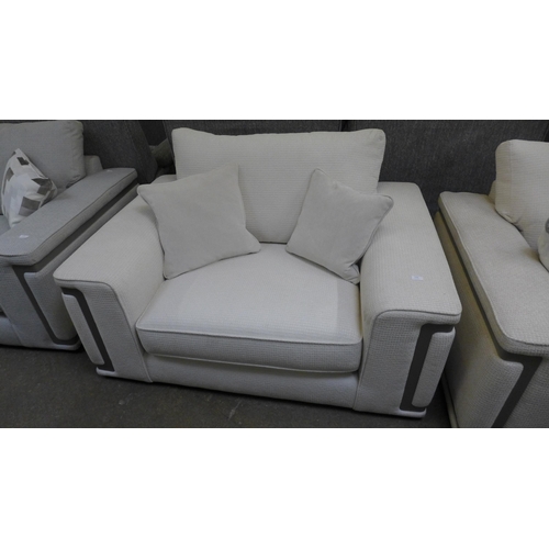 1438 - A cream love seat with steel trim - handling marks