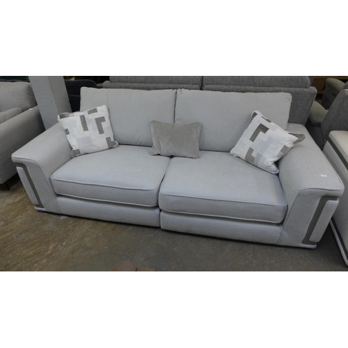 1439 - A grey four seater sofa with steel trim