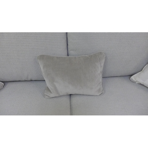 1439 - A grey four seater sofa with steel trim