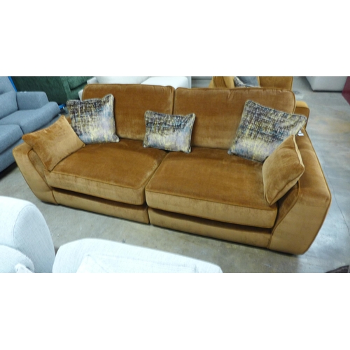 1450 - A turmeric velvet three seater sofa