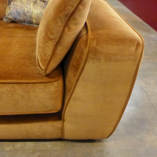 1450 - A turmeric velvet three seater sofa