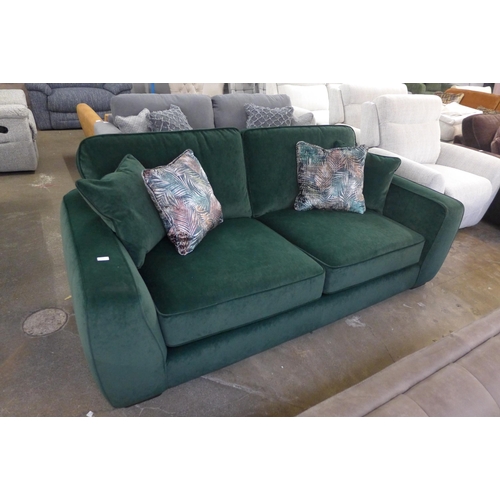 1475 - A deep green velvet three seater sofa